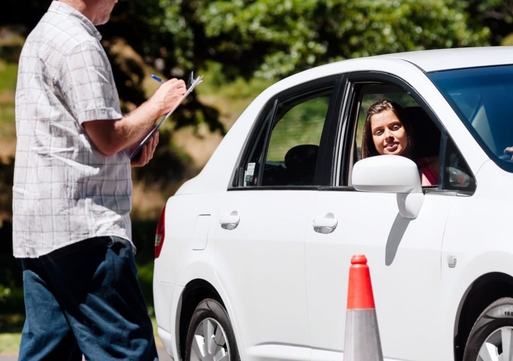 Learner driver girl with intstructor taking lessons