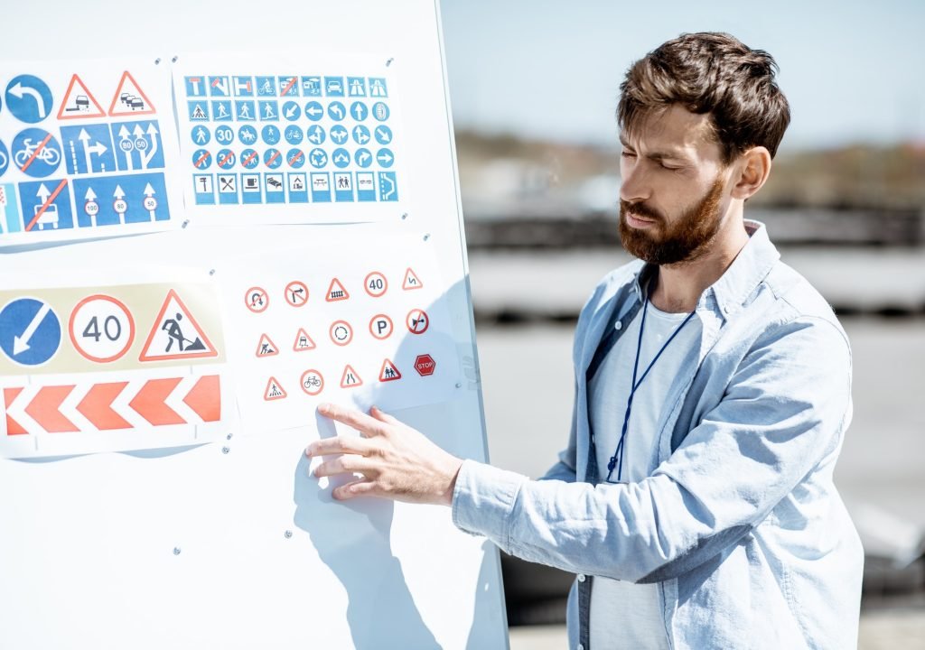 driver-instructor-showing-traffiic-signs.jpg